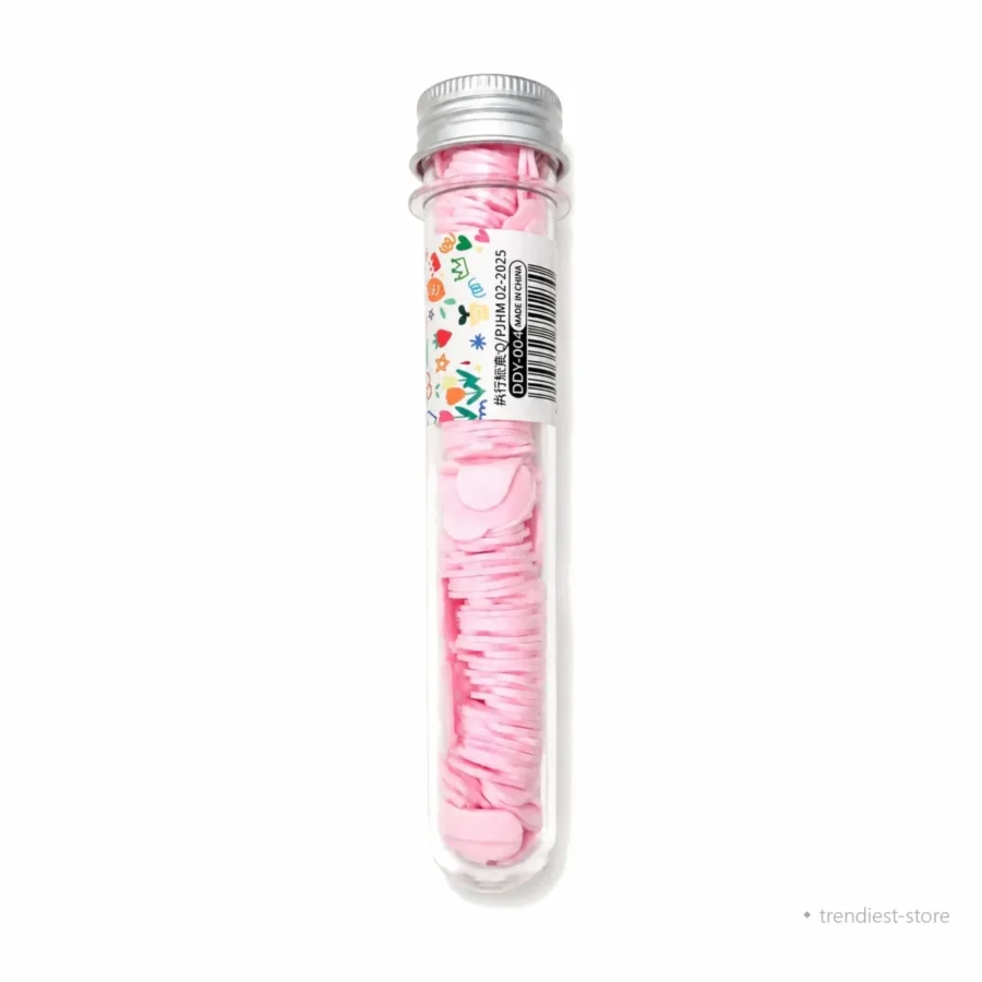 A clear plastic test tube with a silver metal cap, filled with pink heart-shaped wax melts. A colorful decorative label with a barcode is wrapped around the middle of the tube, set against a plain white background.