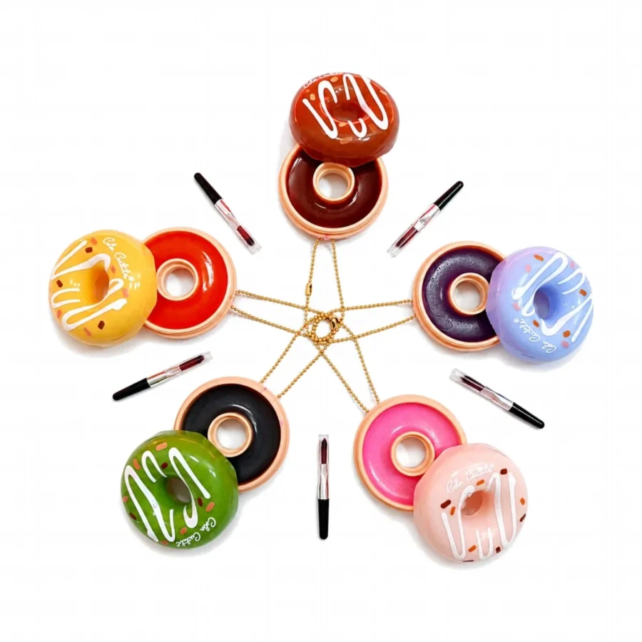 Seven donut lip balm compacts opened to show the tinted balm shades