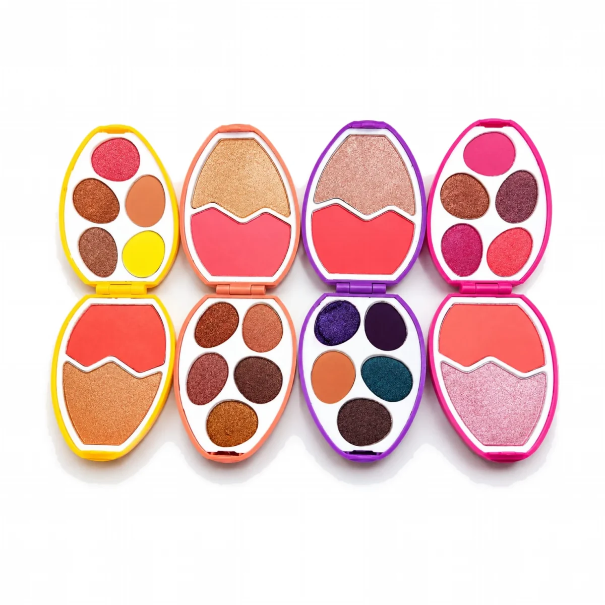 Four egg makeup palettes opened to show eyeshadows, blush and highlighter shades