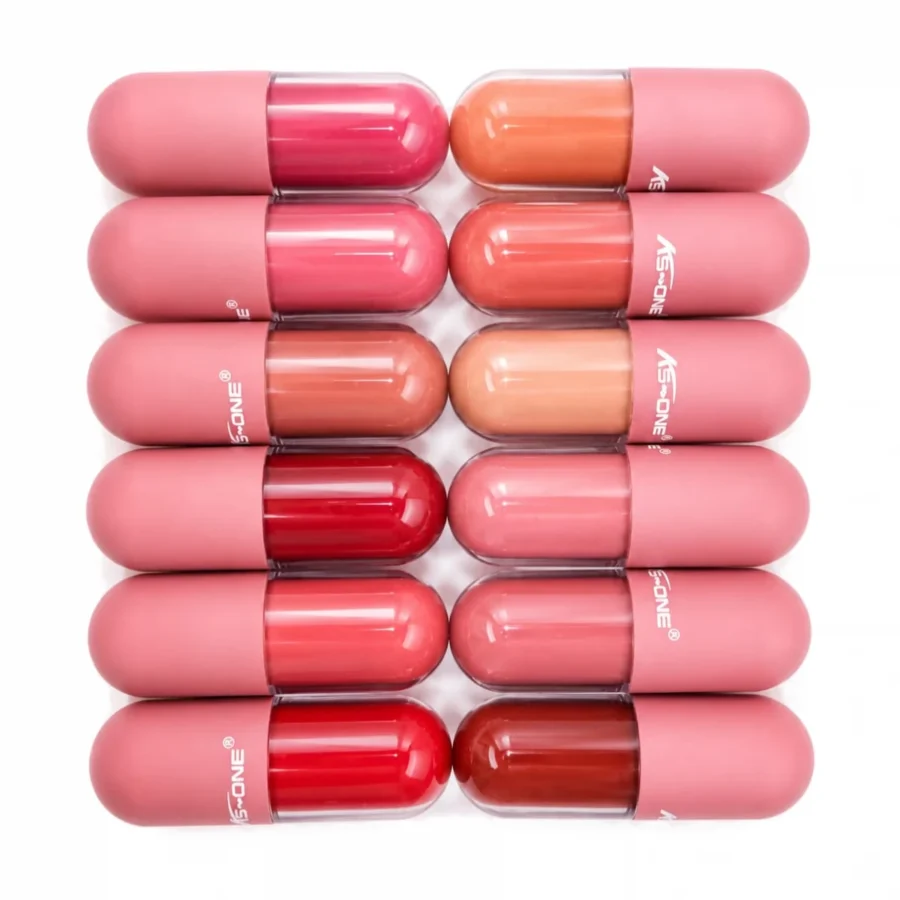 Capsule lip glosses scattered, showing nude and pink shades