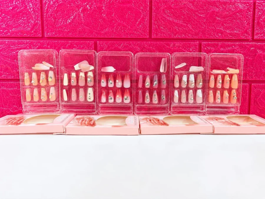 Six boxes of Press-on nails side by side